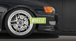 Alloy wheel fitted on a car with wheels written on green background