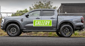 4x4 pickup truck with black off-road wheels and tires