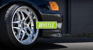 Close-up of a polished alloy wheel on a black performance car.